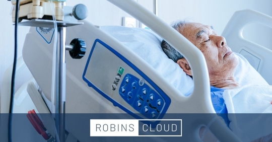 Older man laying down in hospital bed